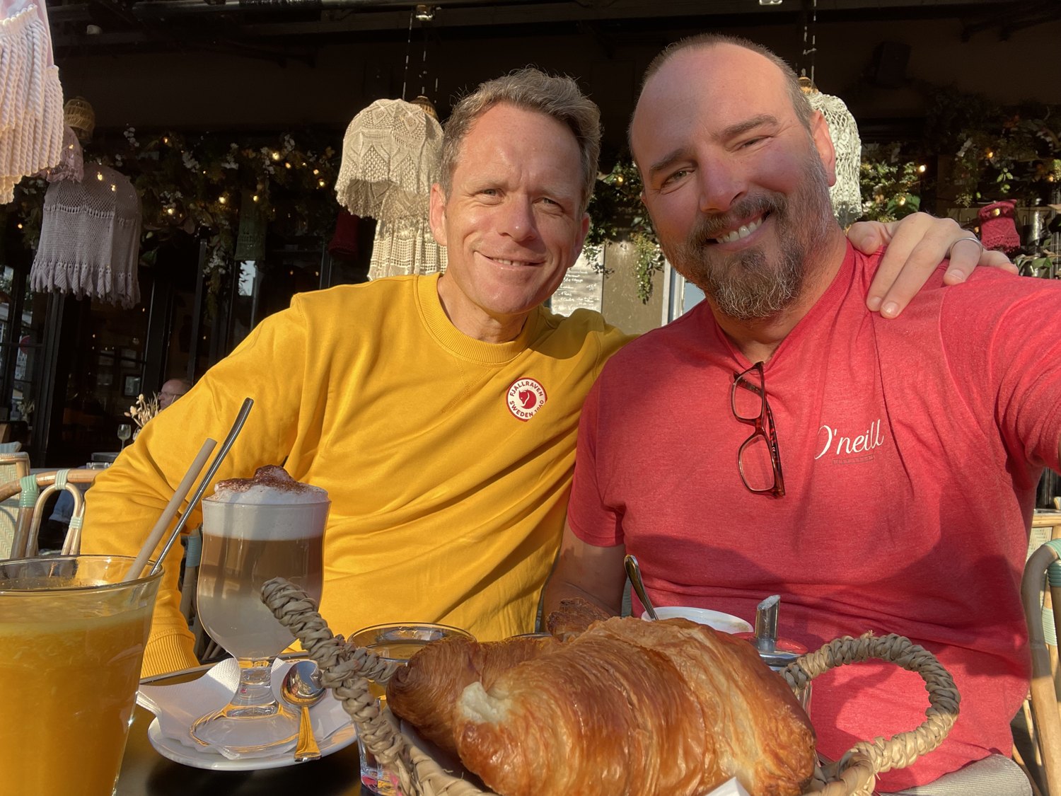 Al and Bilos smiling together over a meal